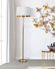 Lampe de sol en métal doré abat-jour en tissu blanc bordures dorées décor transparent